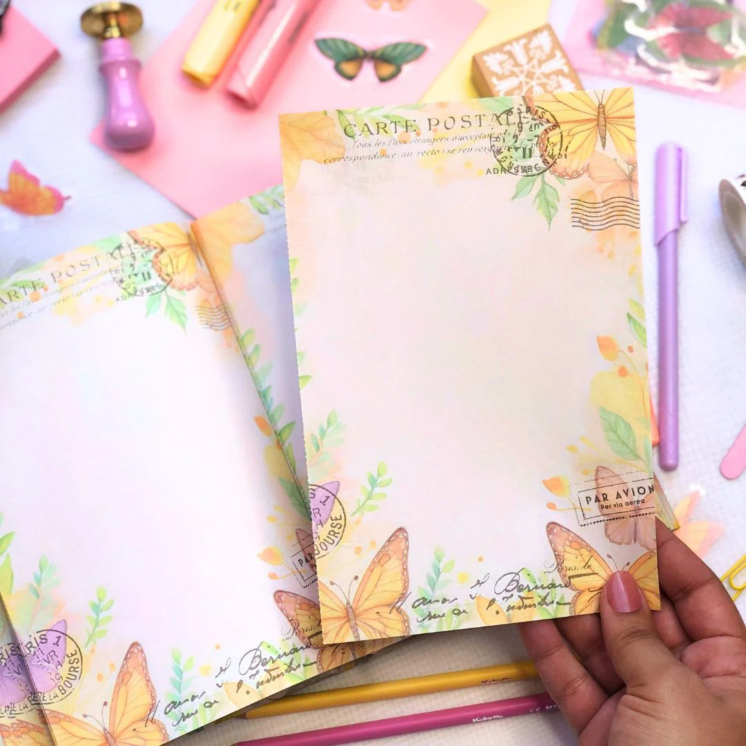 Letters to the future Time capsule Journal with perforated page to tear out surrounded by Colorful stationery items with butterfly designs on a white background