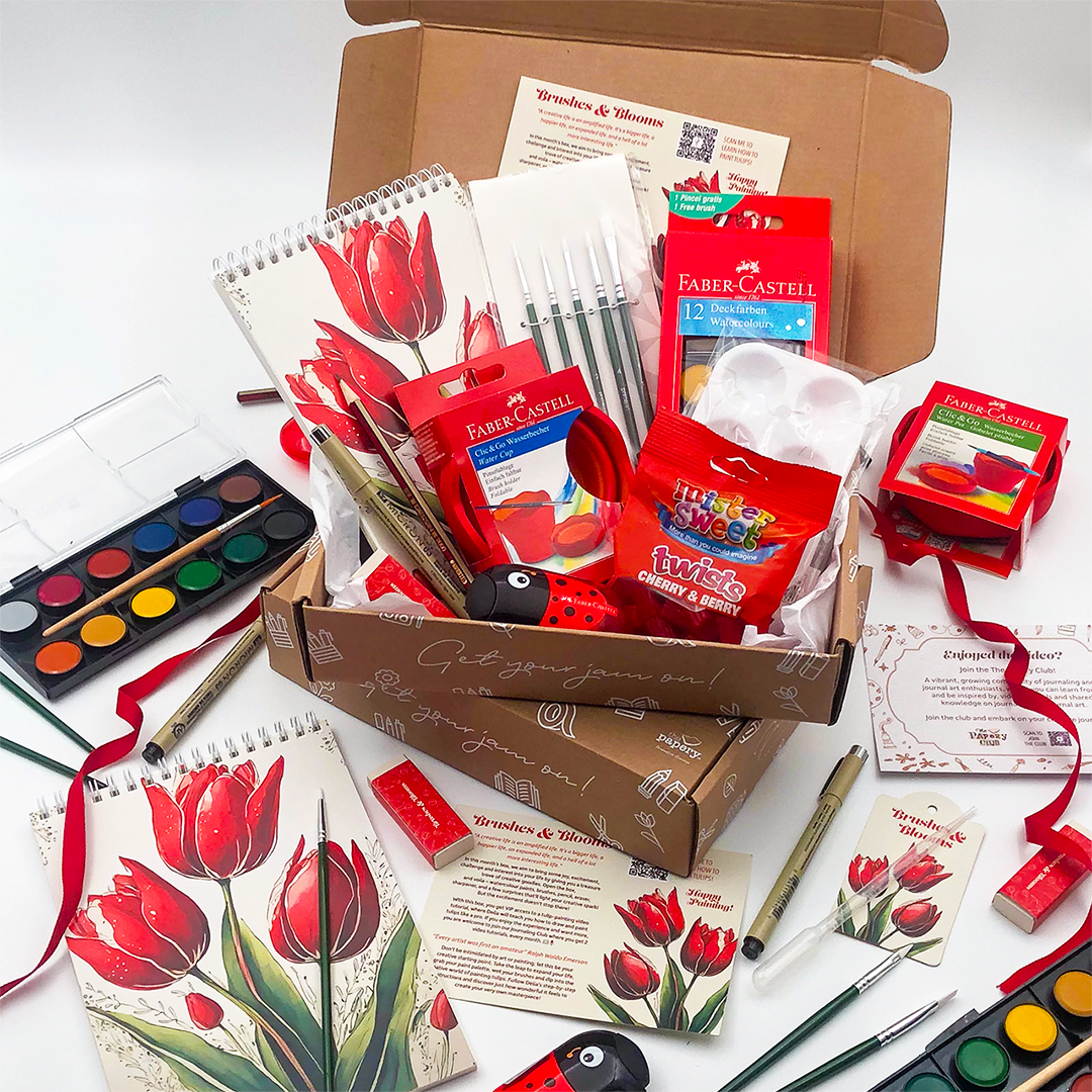 Brushes & Blooms gift Box that rocks has art supply box with filled with goodies on a white background