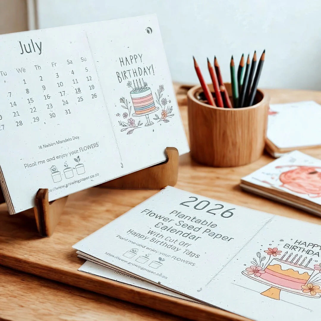 Calendar with birthday design and plantable seed paper on a wooden tray stand