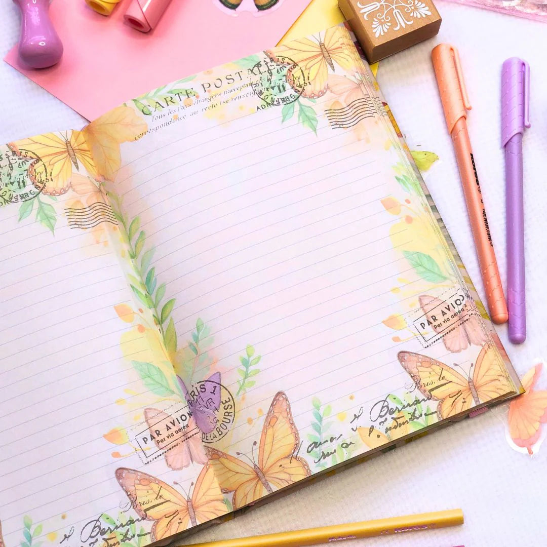 Letters to the future Journal with butterfly design on a desk with stationery items