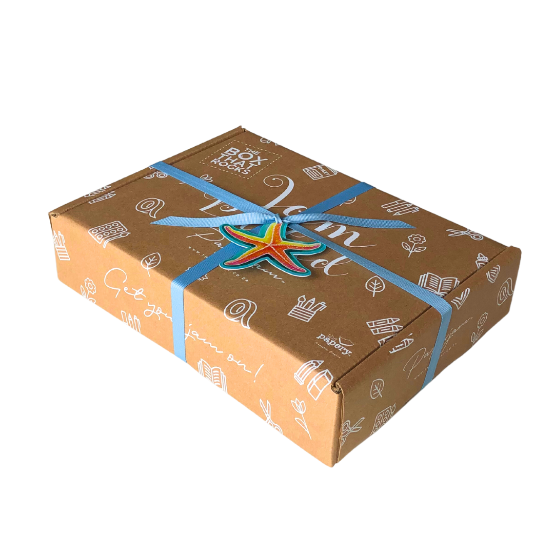 Ocean Treasures Gift box with decorative ribbon and colorful star-shaped tag on a white background