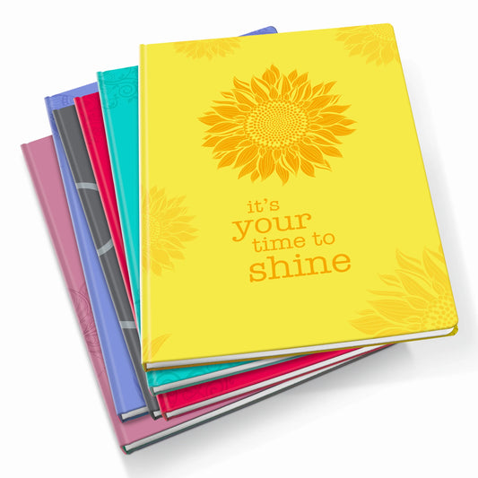 Stack of colorful Scribblz A4 Journal with a yellow one featuring a sunflower and 'it's your time to shine' text.