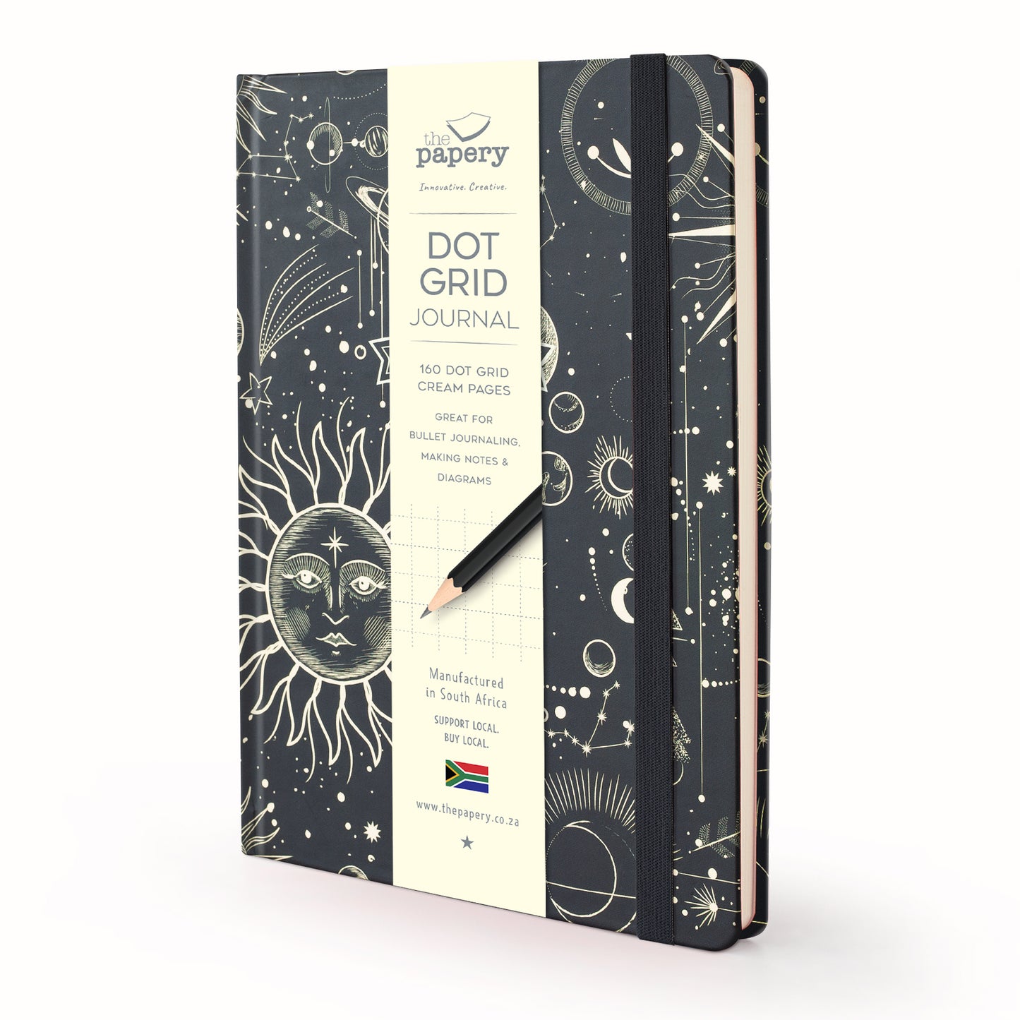 A notebook with a black cover decorated with gold celestial line art, featuring a cream-colored central label that reads 'the papory Dot Grid Journal' and a black pencil resting on top, set against a clean white background.