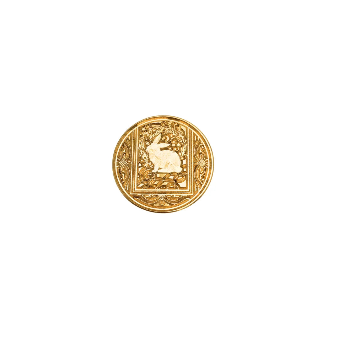 A round gold stamp-seal featuring an embossed rabbit design within a decorative border, set against a plain white background.