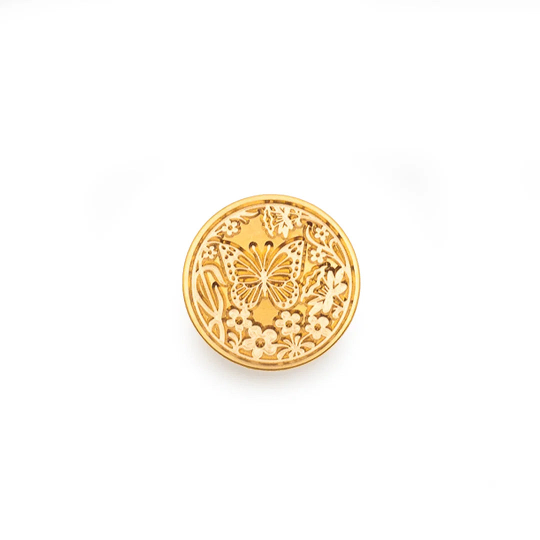 A round gold stamp-seal featuring an embossed butterfly and floral pattern, shown on a plain white background.