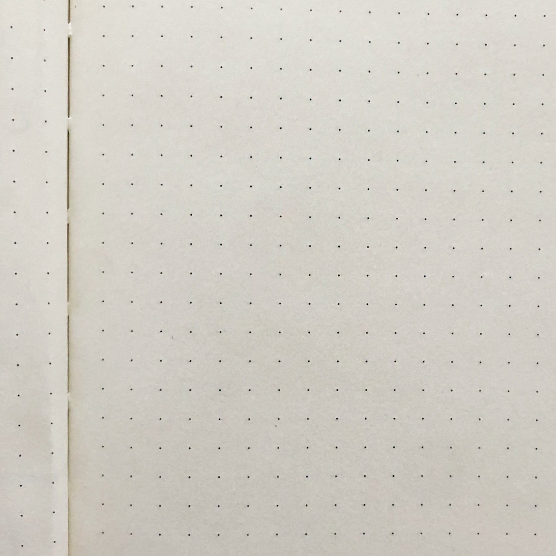 Junk Journal Close-up of a white sheet with small black dots on the pages on a white background