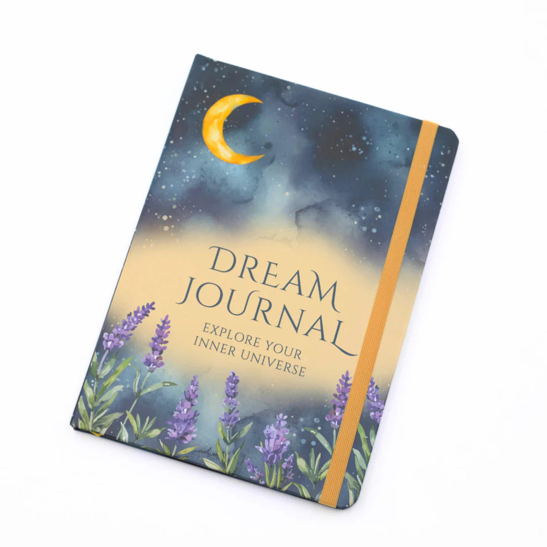 Front cover of Dream journal with celestial design, crescent moon, and lavender flowers with matching ribbon on a white background