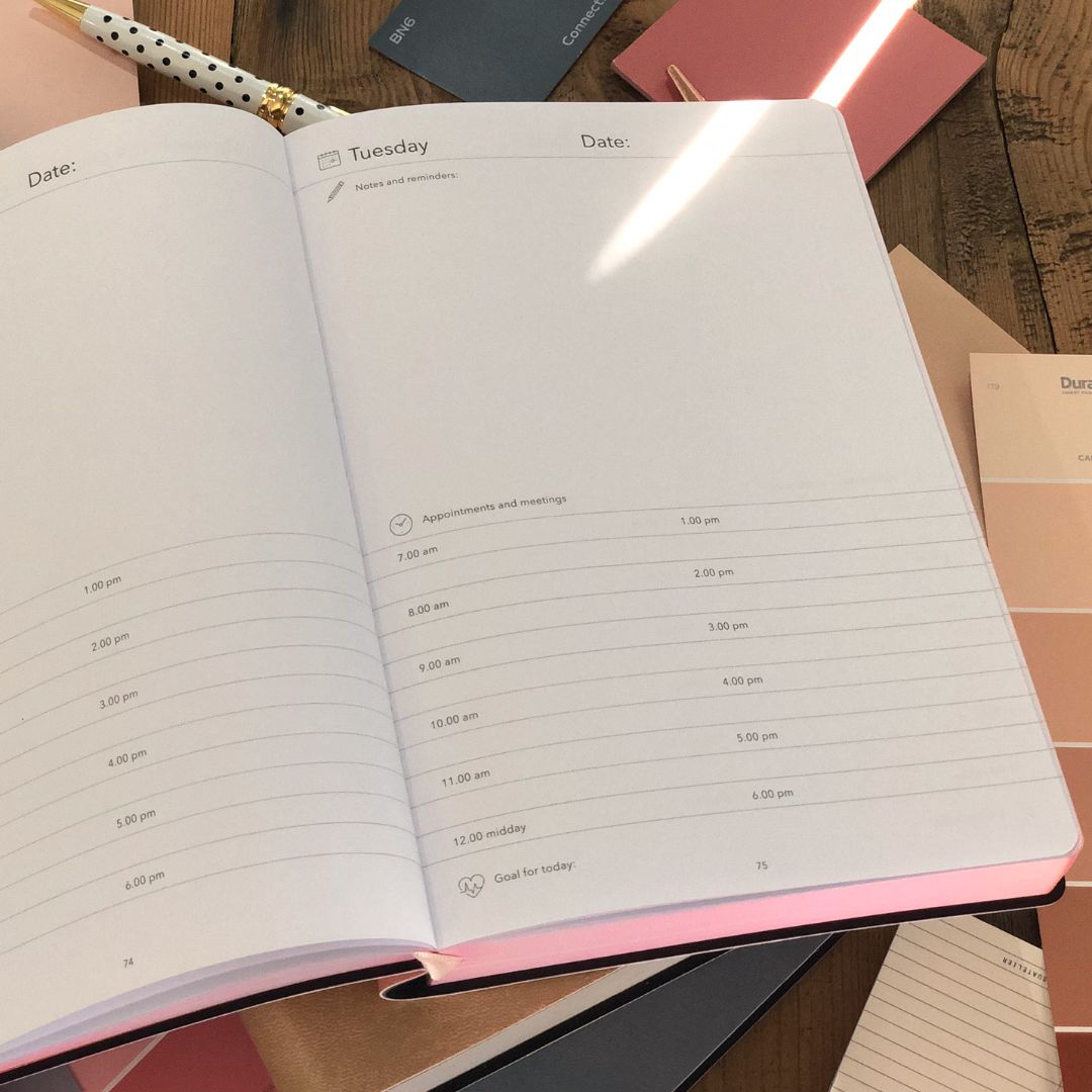 Open Flexi Multi-Planner with daily schedule on a wooden surface