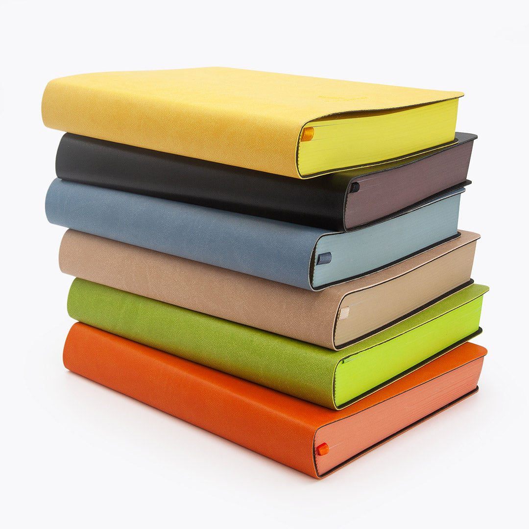 Stack of colorful Flexi Multi-Planner in leatherette on a white background