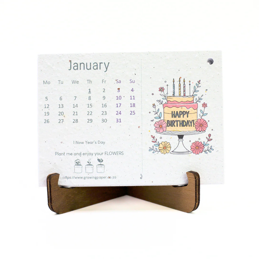 Calendar with a birthday cake design and wooden stand on a white background