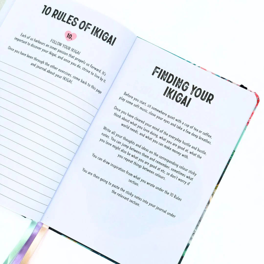 Open journal workbook with '10 Rules of Ikigai' and 'Finding Your Ikigai' text on a white background