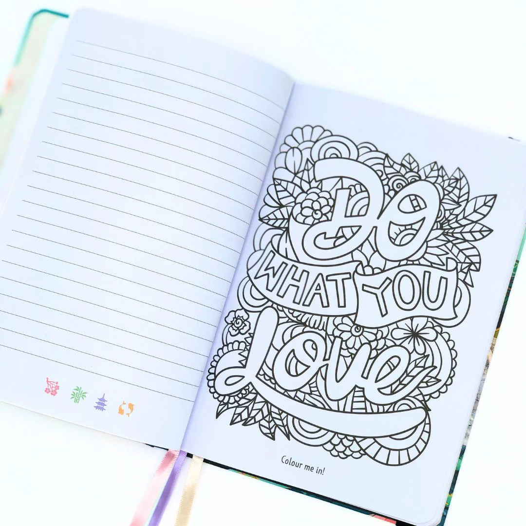 Open journal with a coloring page featuring decorative text 'Do what you love' to color in and floral elements.