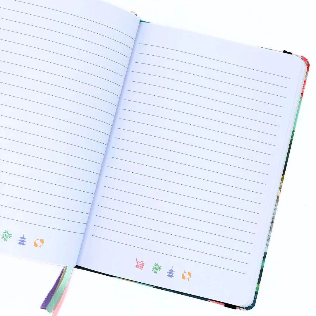 Open journal with lined pages and colorful decorative elements on a white background