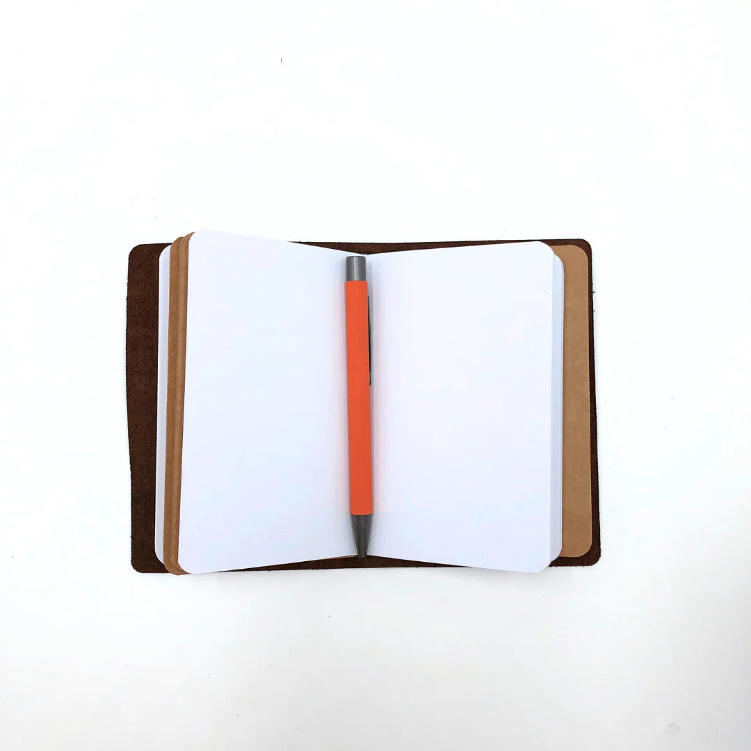 Open notebook with a pen on a white background