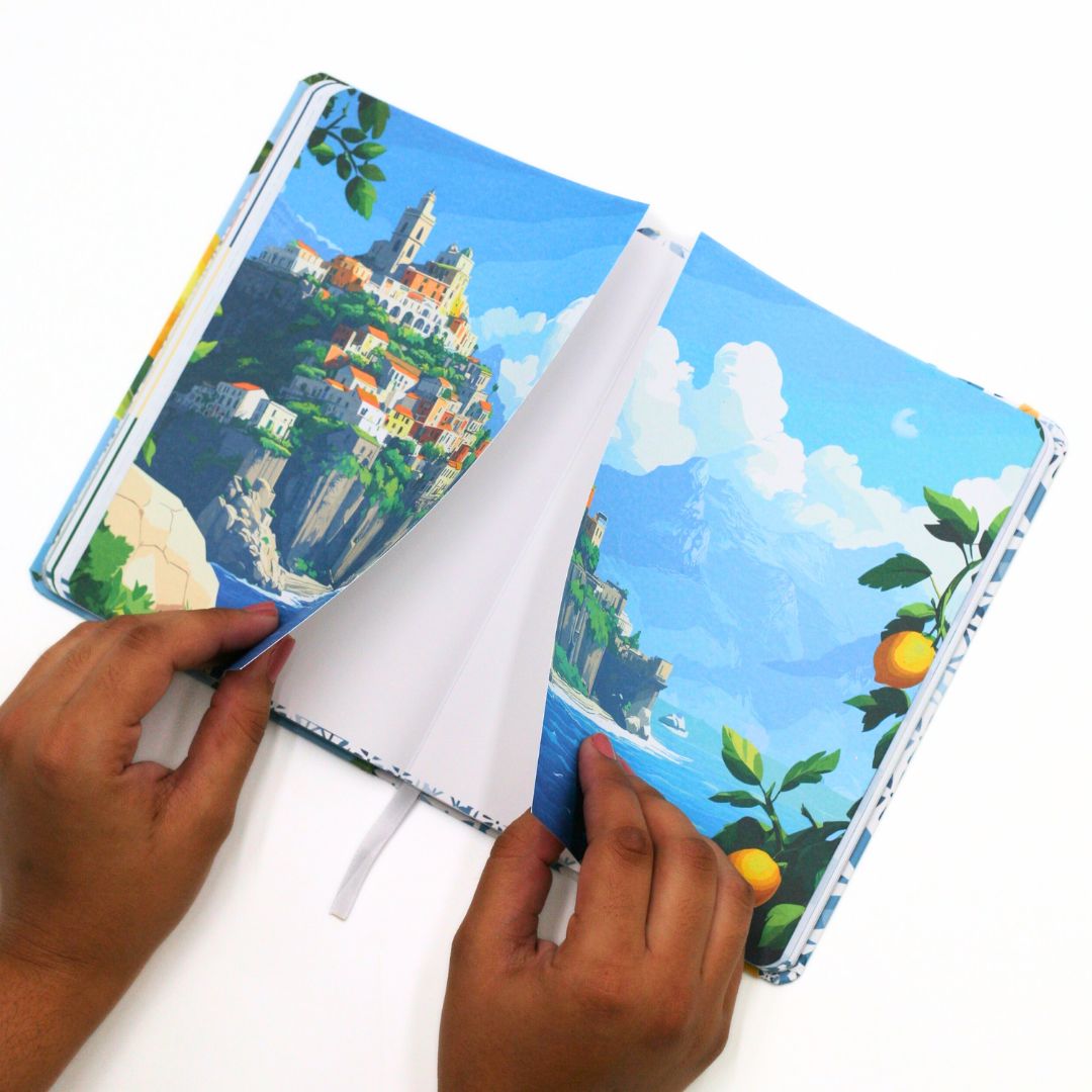 Open La Dolce Vita Life is beautiful guided vision Journal with an iconic scenic vision board that opens up held by hands on a white background