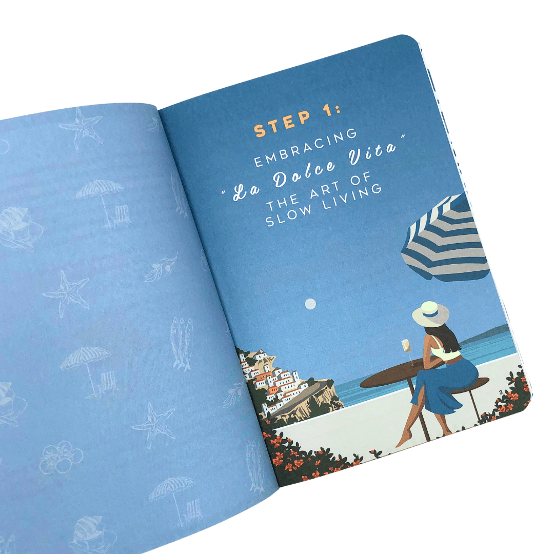 Open La Dolce Vita Life is beautiful guided vision Journal with a blue cover featuring an illustration of a woman at a beach and text about 'La Dolce Vita' and slow living.