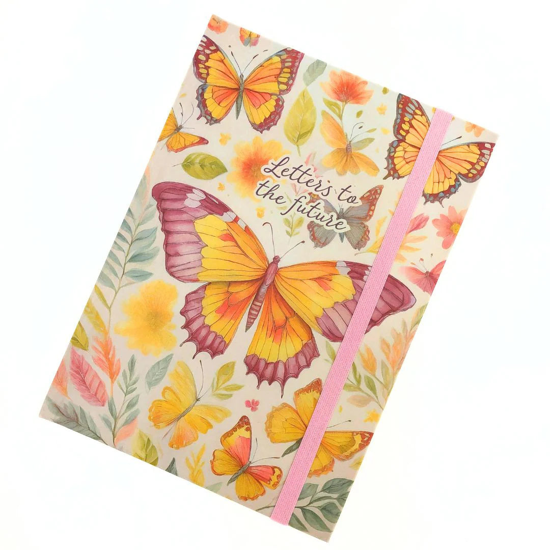 Front cover of Letters to the future Journal with butterfly design and matching pink ribbon on a white background