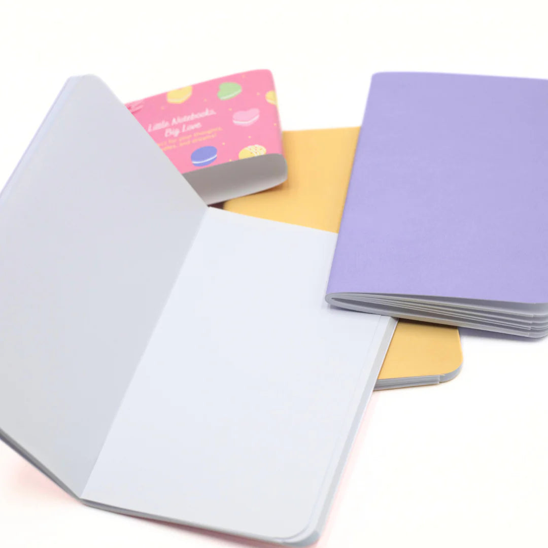 Open Love and Macaron notebook with inside pages on a white background