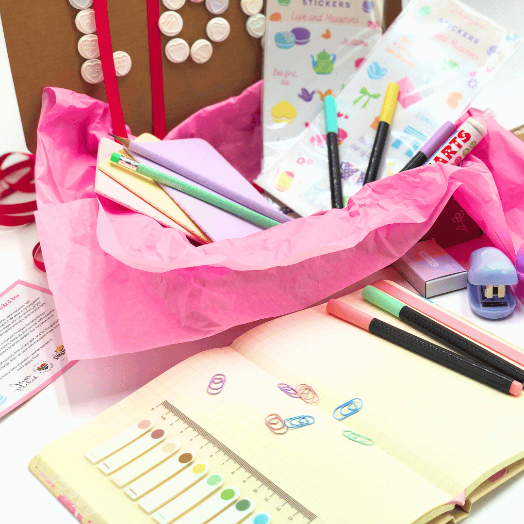 Love and Macaron Gift Box has colorful stationery items including pens, stickers, and a notebook on a white background.