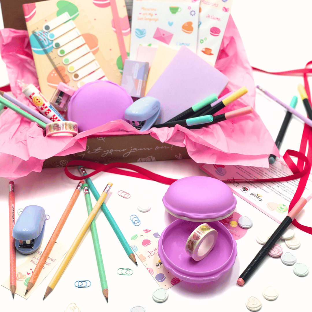 Love and Macaron Gift Box includes stationery items including pens, pencils, and a pastel eraser on a white background.