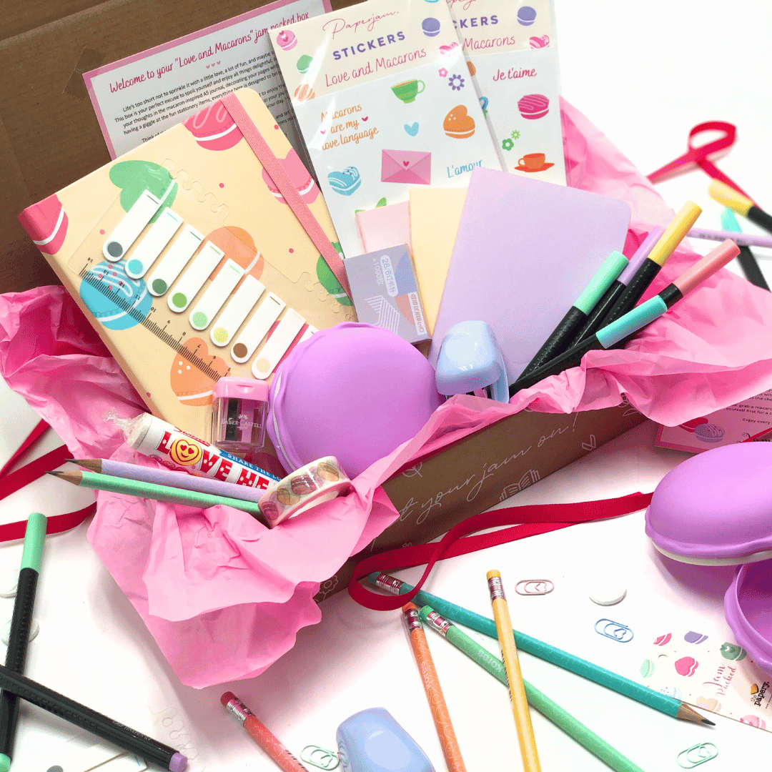 Love and Macaron Gift Box has stationery items including notebooks, pens, and stickers in a box with tons of hidden gems.