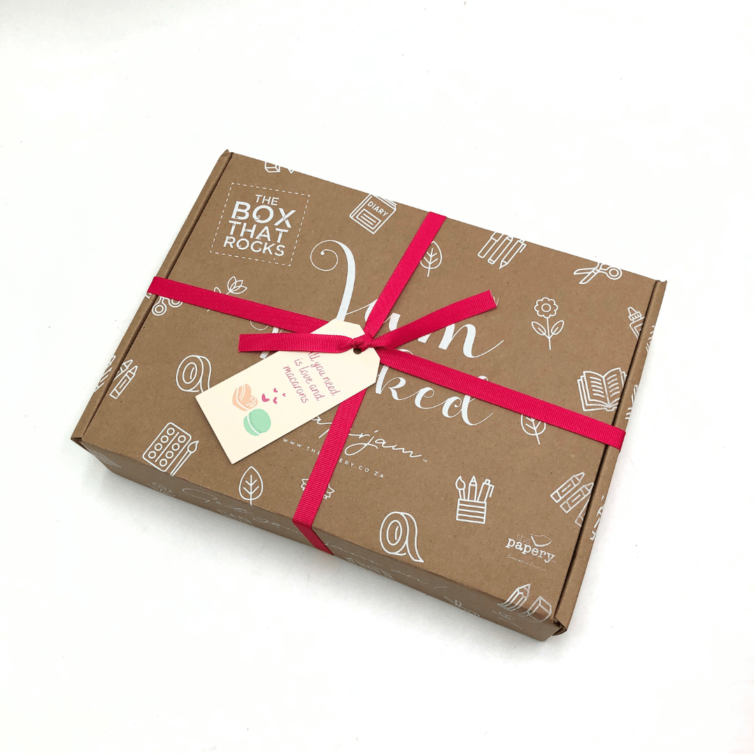 Brown Love and Macaron Gift Box with red ribbon and decorative tag on a white background