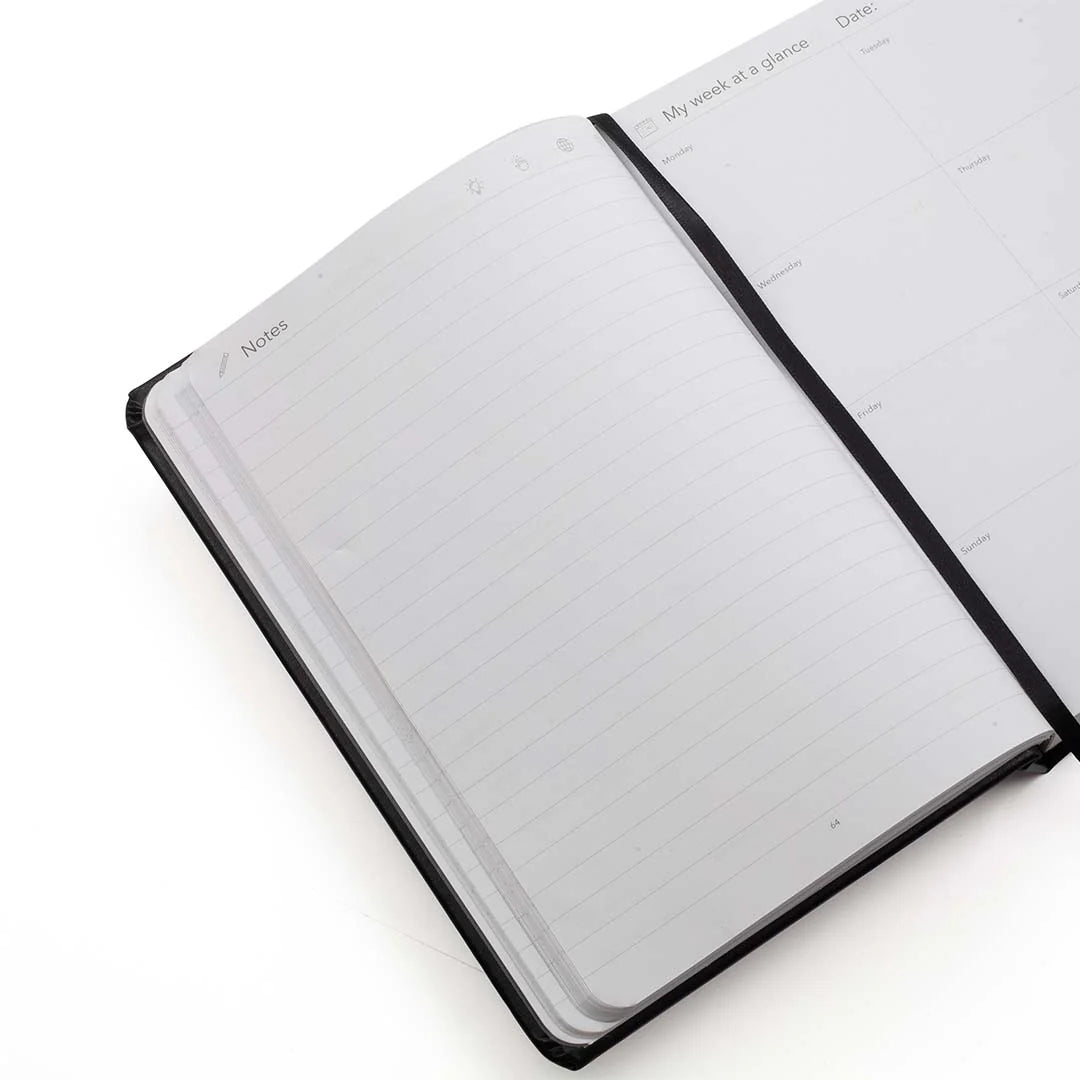 Open planner with notes pages on a white background