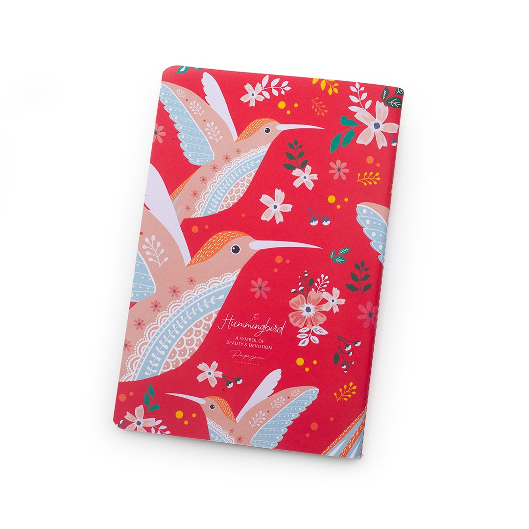 Notebook with pink hummingbird design on a background