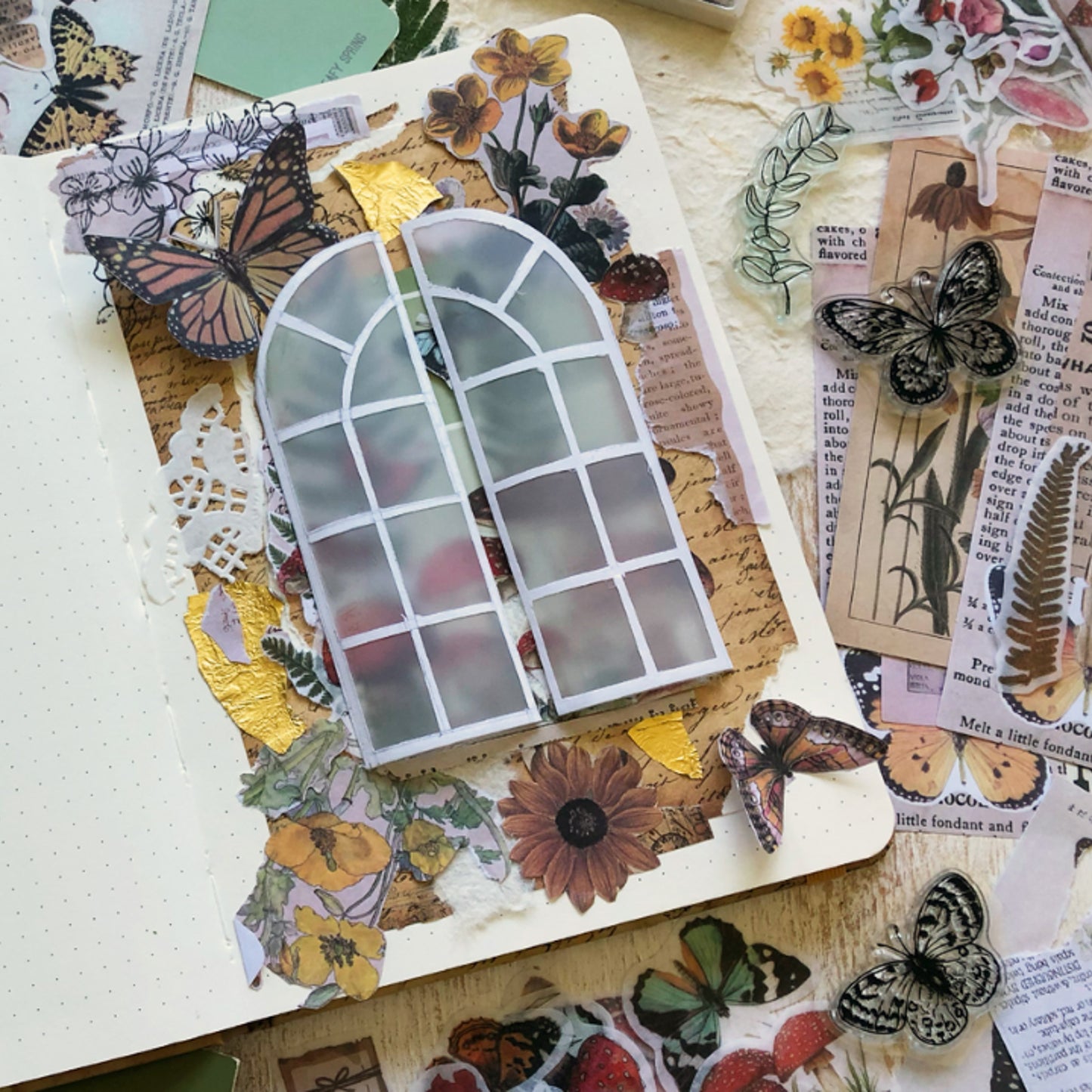 Junk Journal Collage of nature-themed stickers with a window design on a wooden surface.