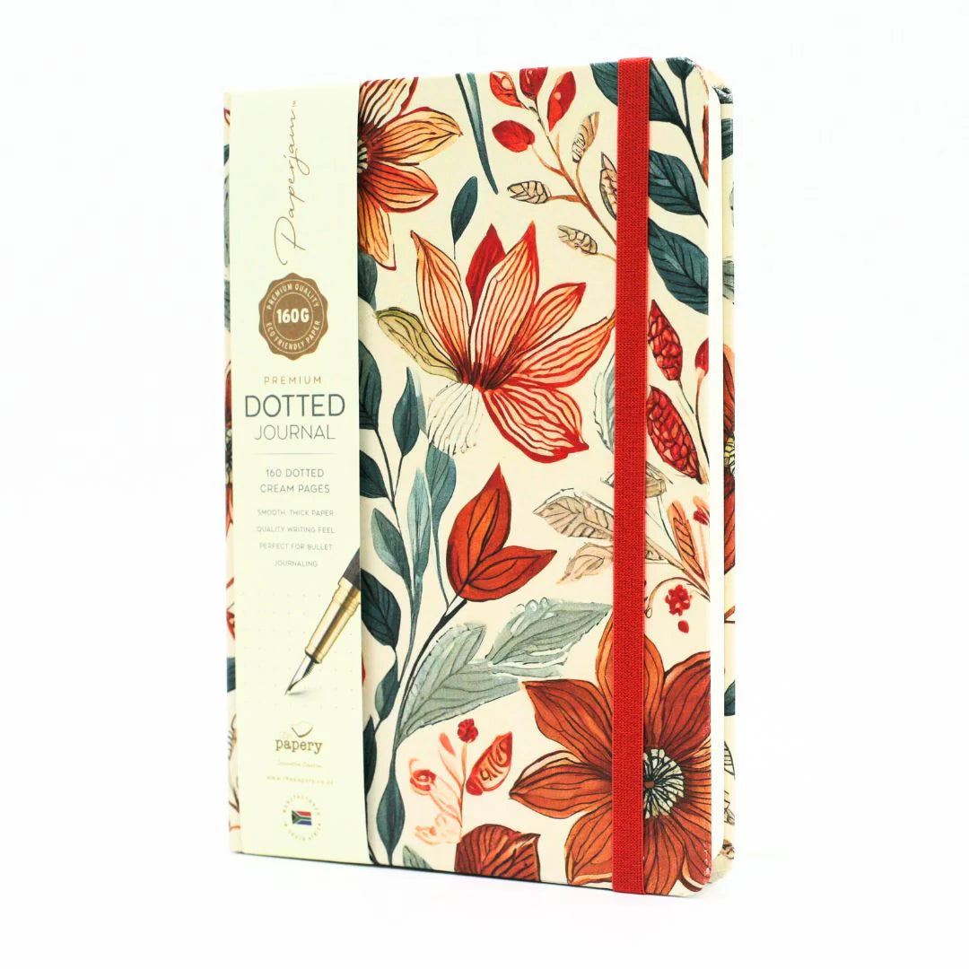 Front cover of premium hardcover dotted journal with autumn garden design with matching ribbon on a white background