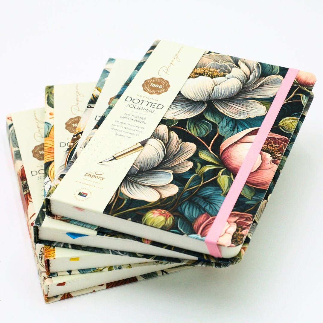 Stack of Premium Dotted Designer Journal A5 journals with matching ribbons on a white background