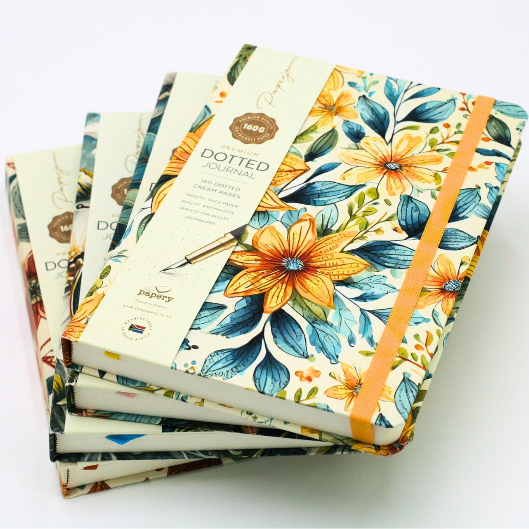 Stack of premium hardcover dotted journal on a white background