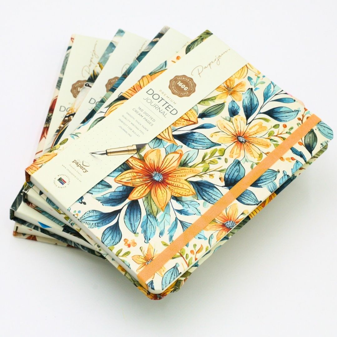 Stack of premium hardcover dotted journal on a white background