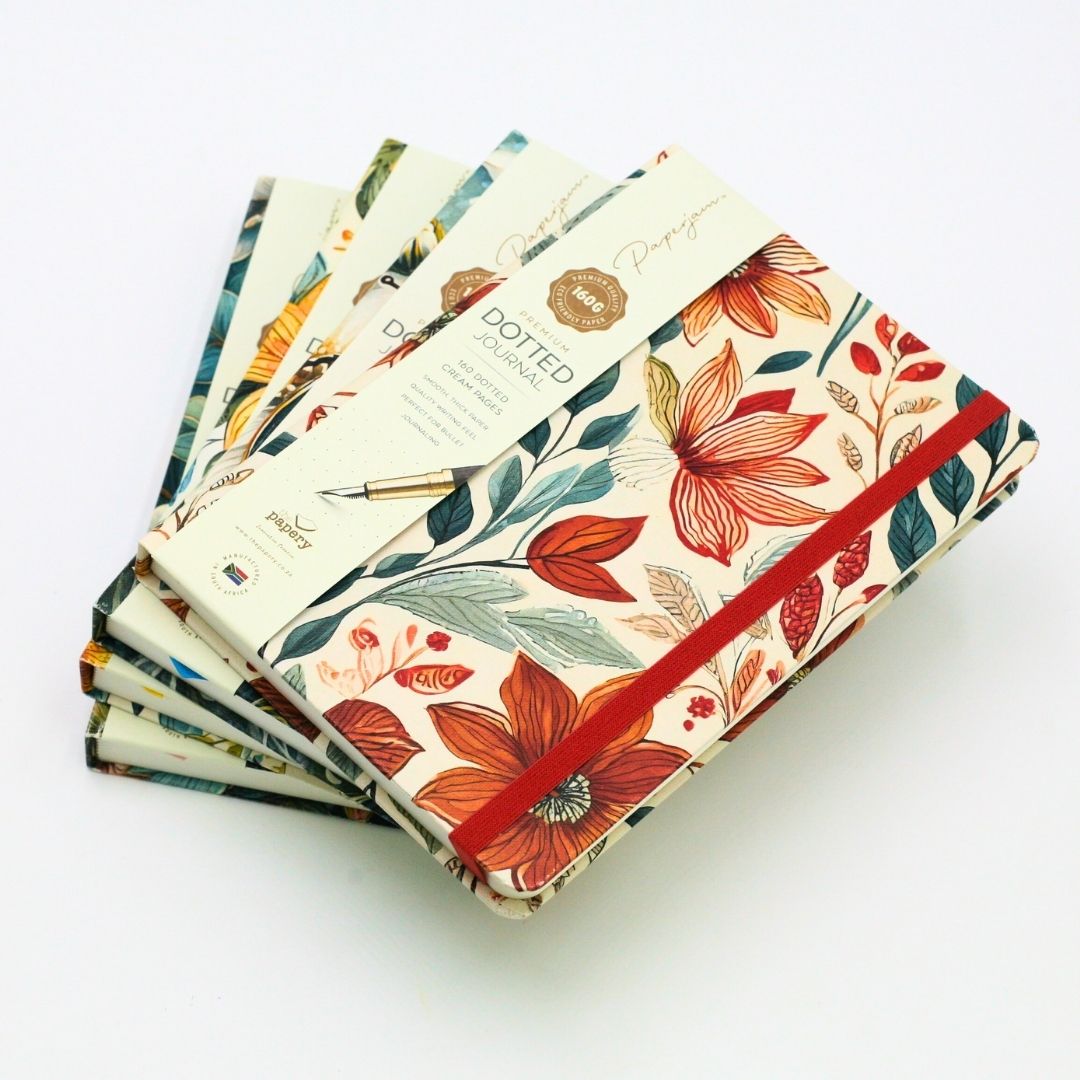 Stack of premium hardcover dotted journal on a white background