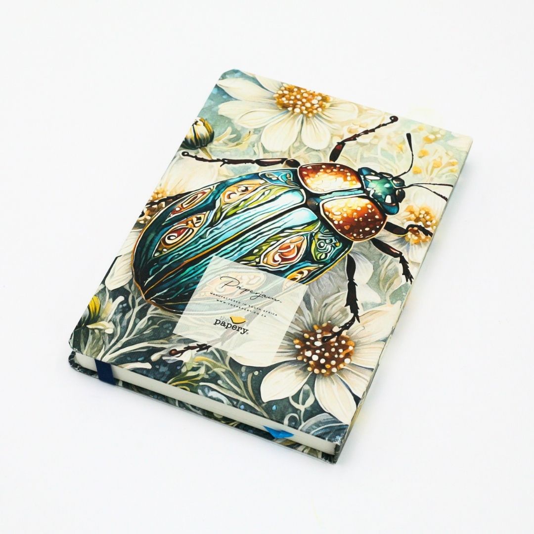 Back cover of premium hardcover dotted journal with iridescent scarab design on a white background