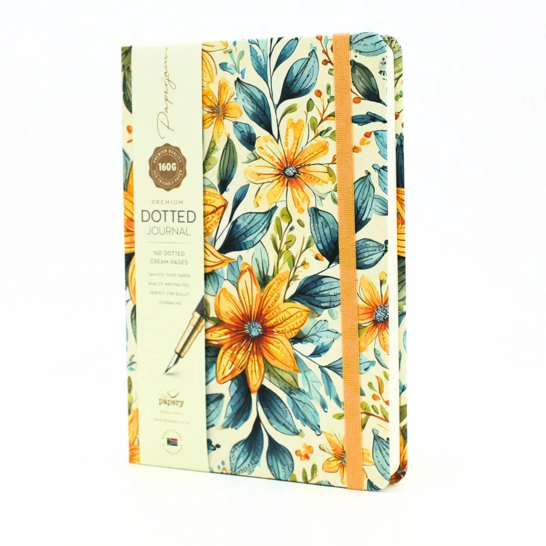 Front cover of premium hardcover dotted journal with summer garden design with matching ribbon on a white background