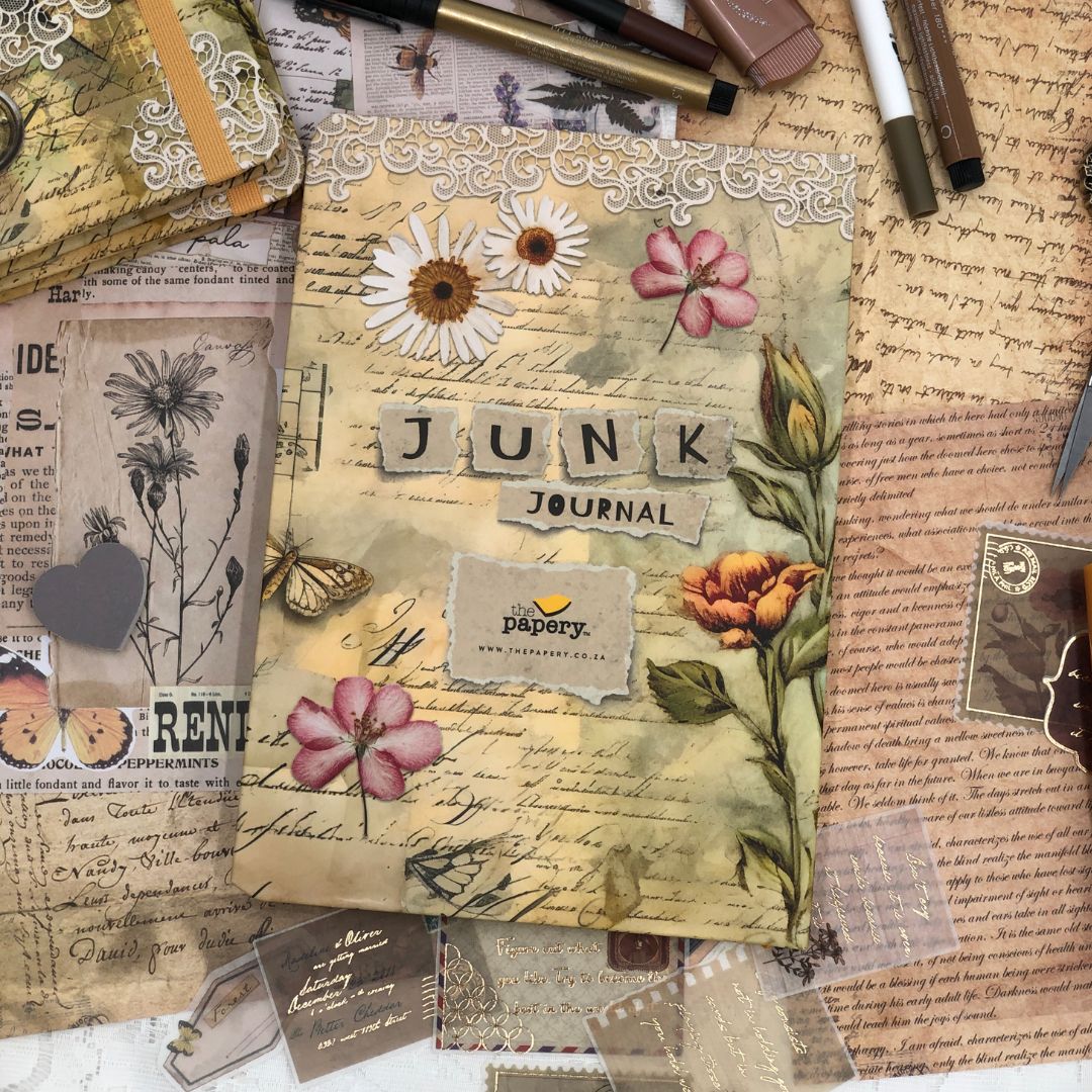Decorative back cover of junk journal with floral designs and text on a textured surface.