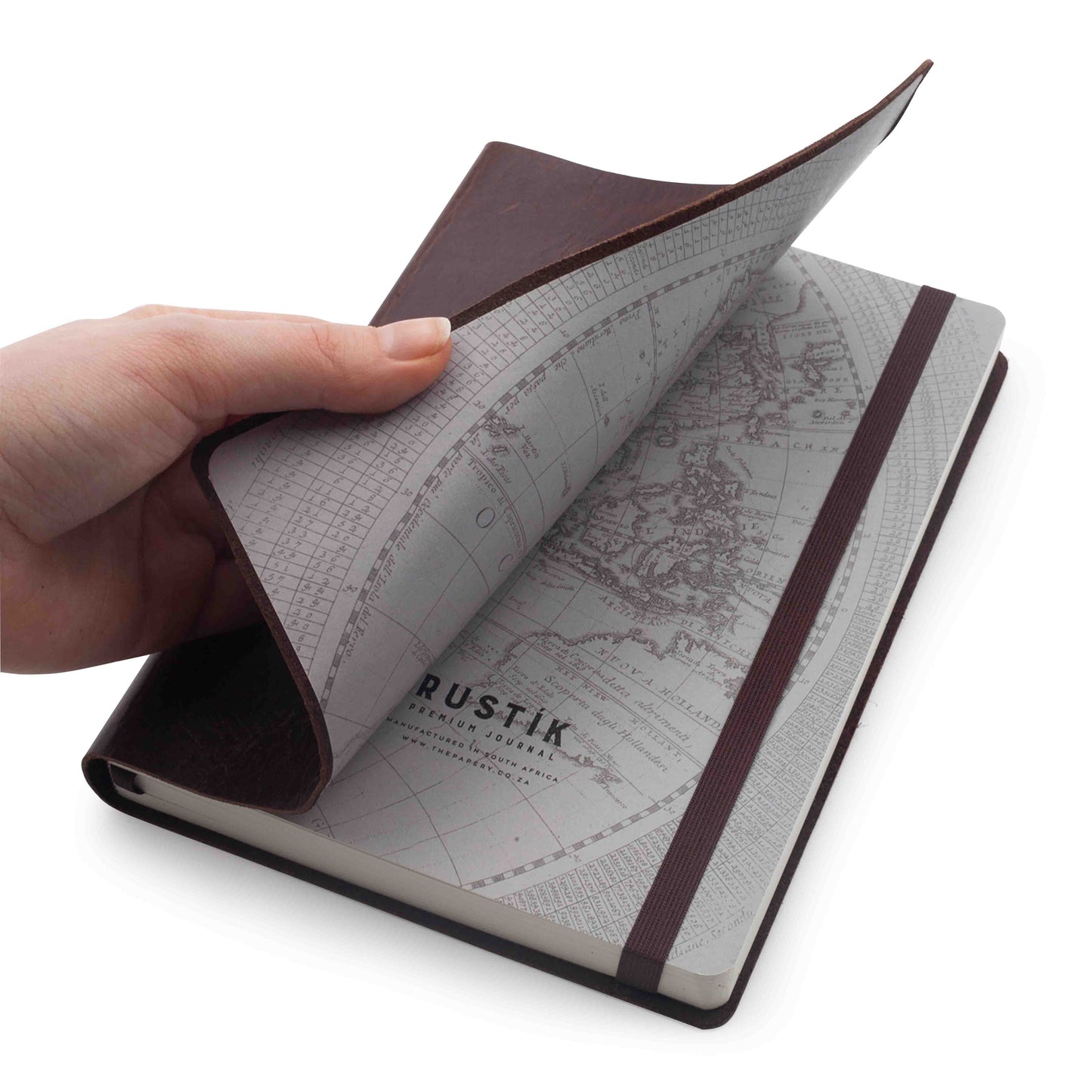 Hand holding a genuine leather notebook with world map design on a white background