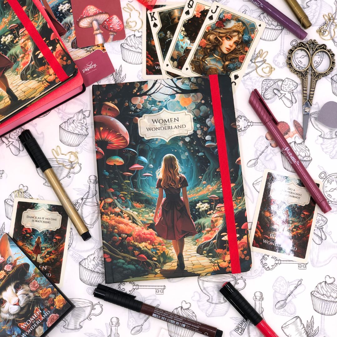 Retro Journal titled 'Women Wonderland' surrounded by decorative and curated cards and pens on a patterned background