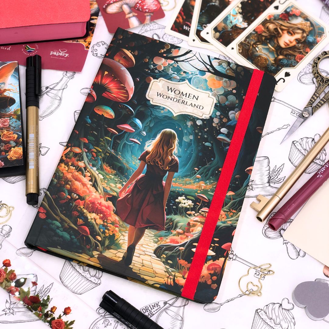 Retro Journal titled 'Women Wonderland' on a surface with artistic items and stationery.