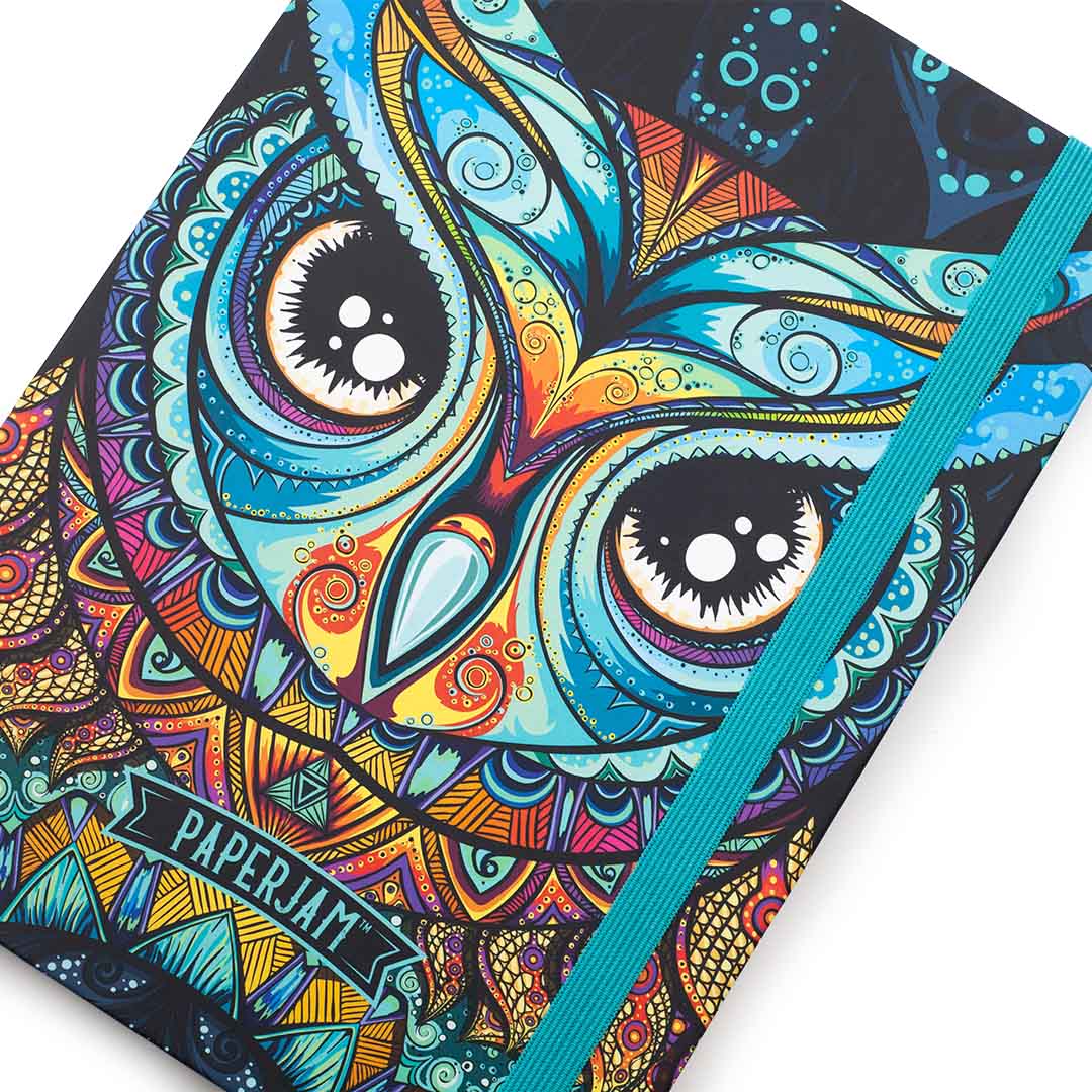 A close-up of a notebook cover featuring a colorful, highly detailed owl illustration with intricate mandala-like patterns. The cover is black with bright turquoise, orange, yellow, and purple details.