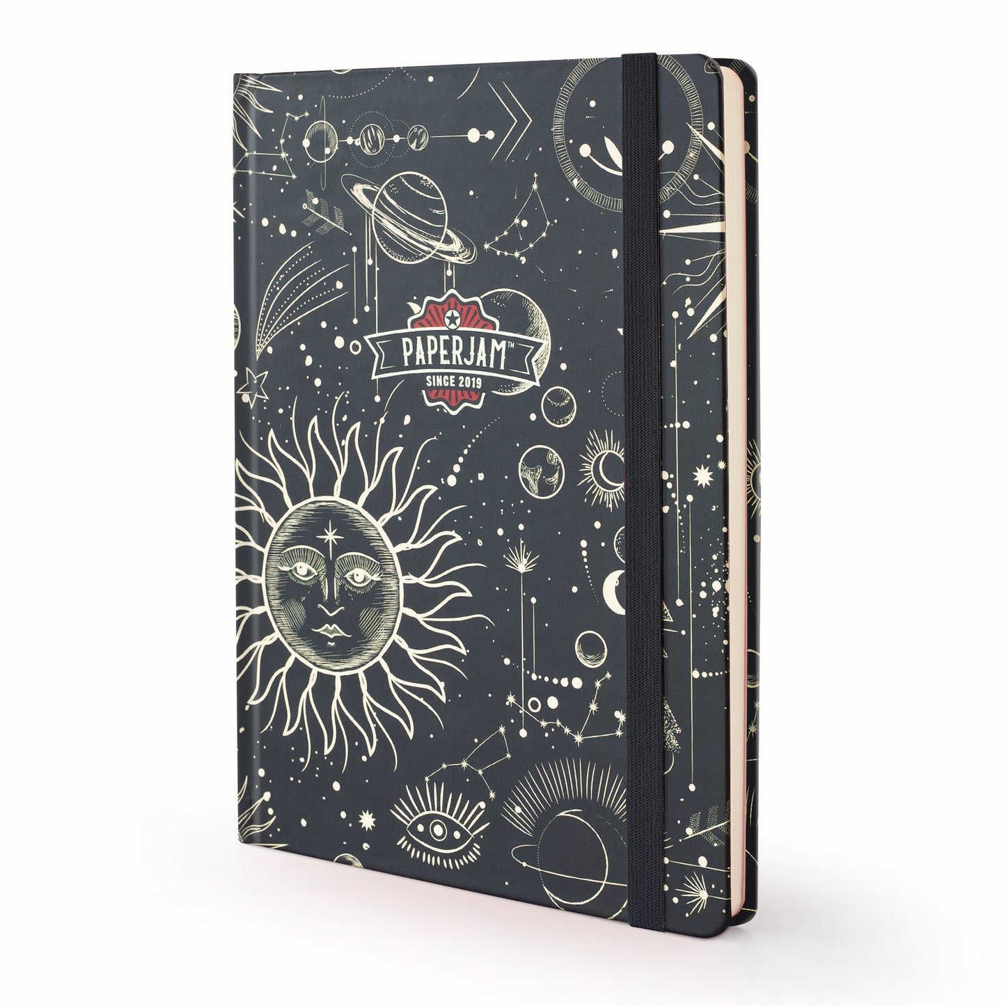 A hardcover notebook with a dark navy blue cover decorated with cream-colored celestial illustrations, including a sun, moon, planets, and stars. A black elastic closure band is wrapped around the right side.