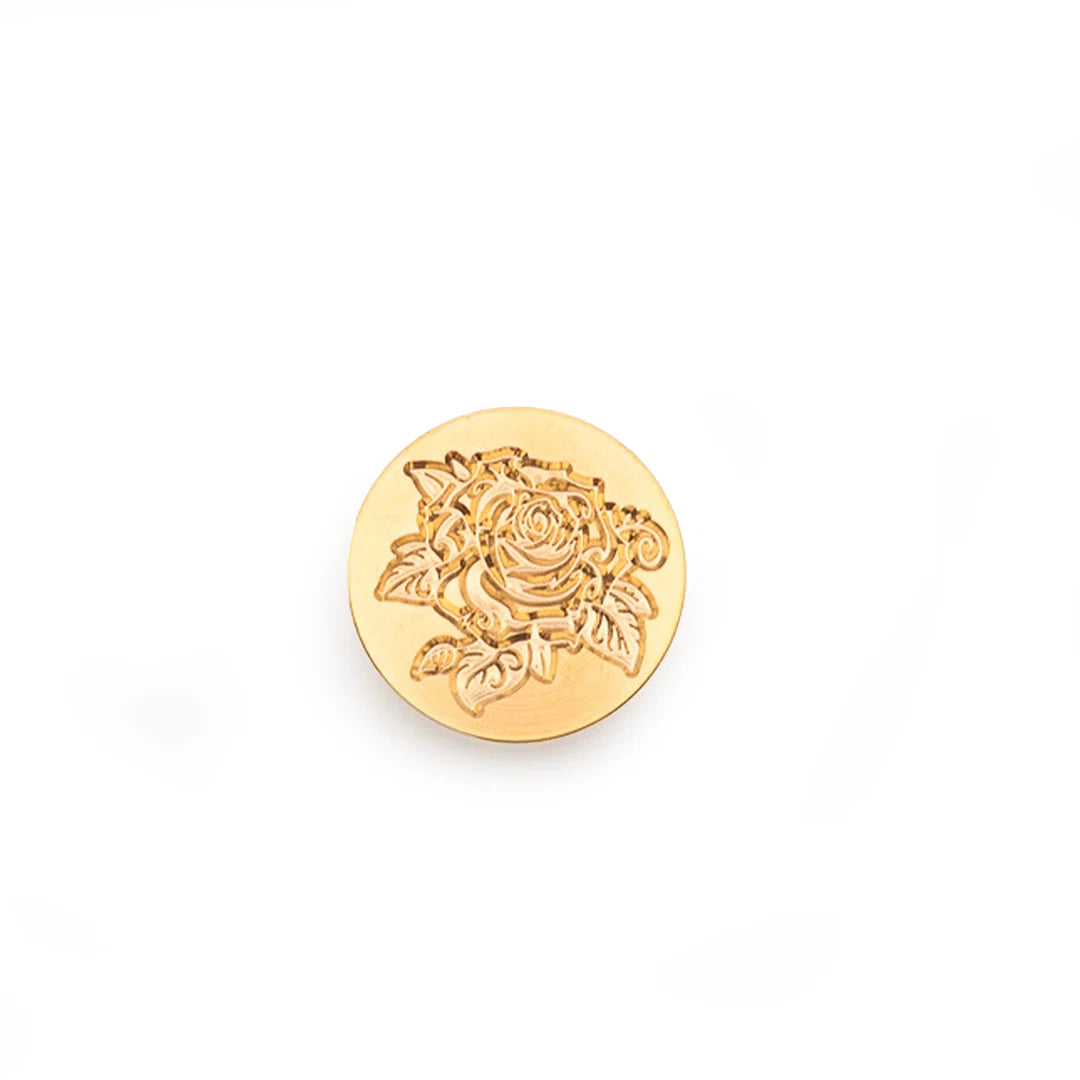 A round gold stamp-seal featuring an embossed rose design, shown on a plain white background.