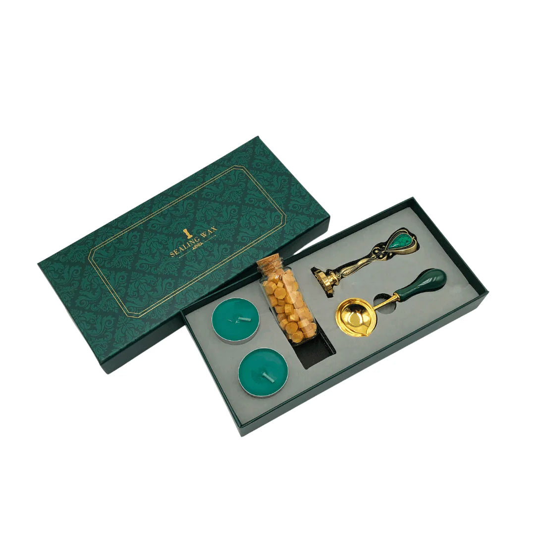 Sealing Wax Set of decorative items including candles and a stamp in an open green box on a white background.