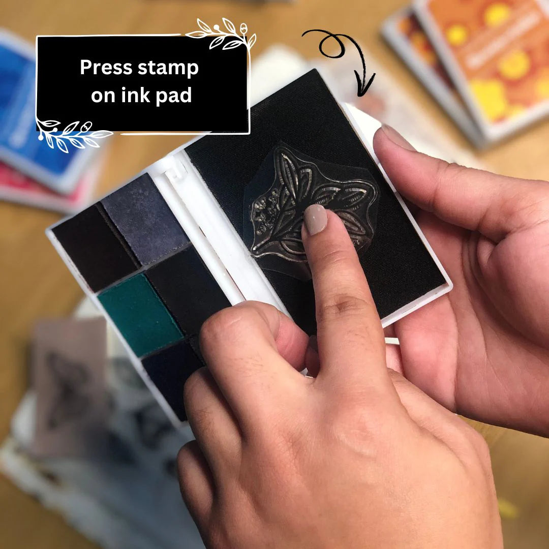 Step to use ink pad by pressing a stamp onto an ink pad with text 'Press stamp on ink pad' above.