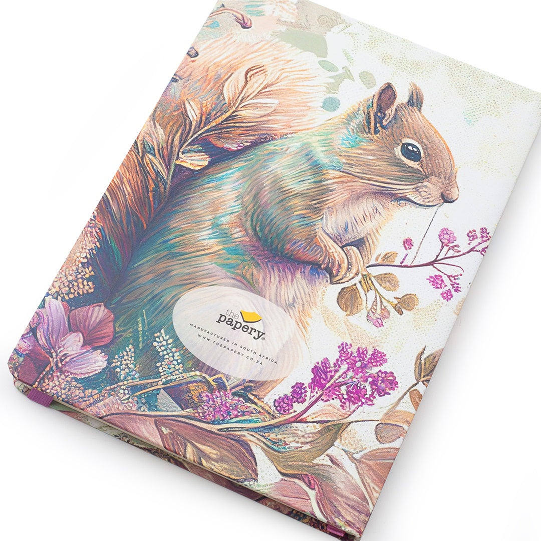 A notebook with a detailed illustration of a squirrel on the cover, featuring a white oval label in the center that reads 'papyry'. The notebook is photographed at an angle against a clean white background.