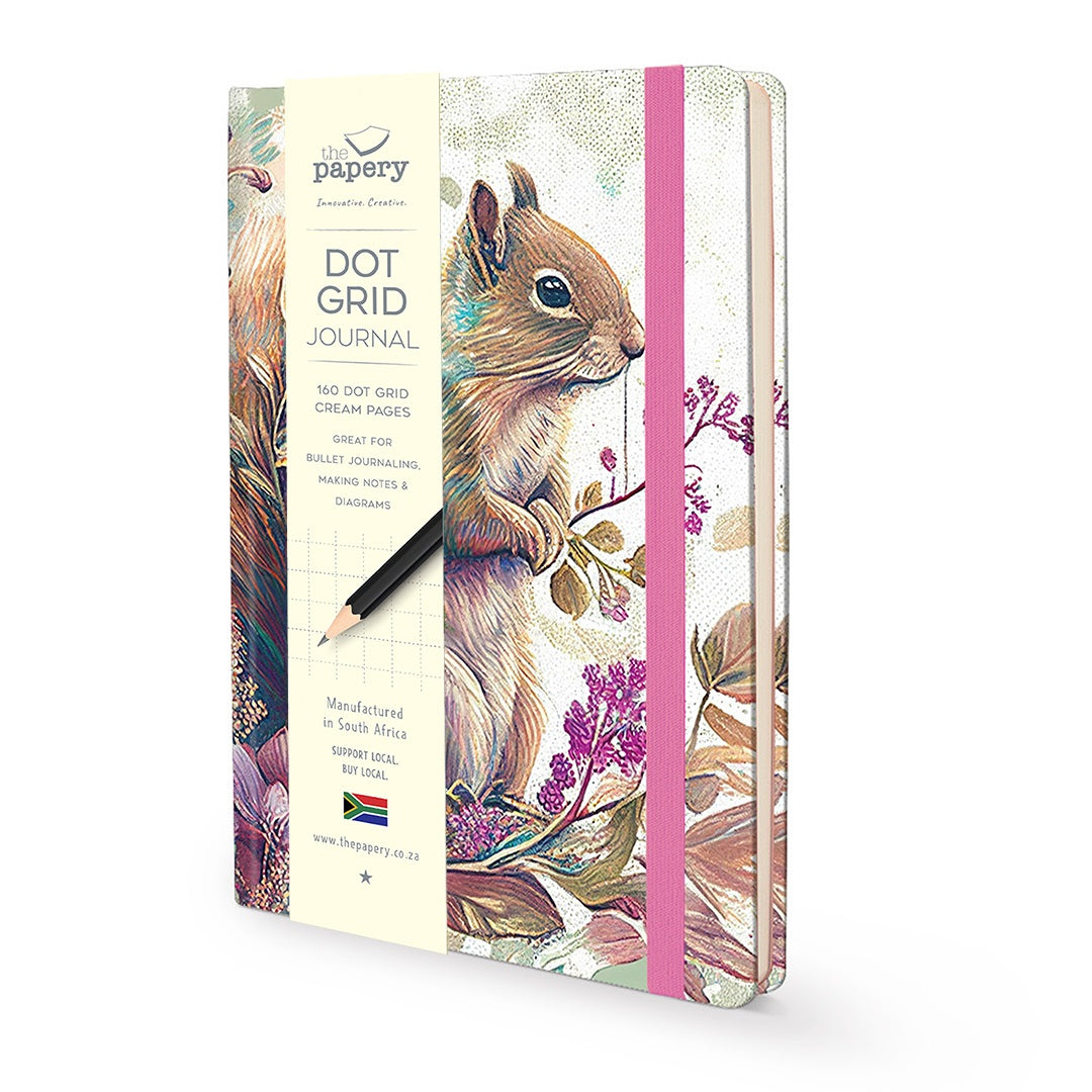 A 120-dot grid journal by The Papery, featuring a detailed illustration of a squirrel on the cover, a pink elastic closure band, and a black pencil resting on the front.