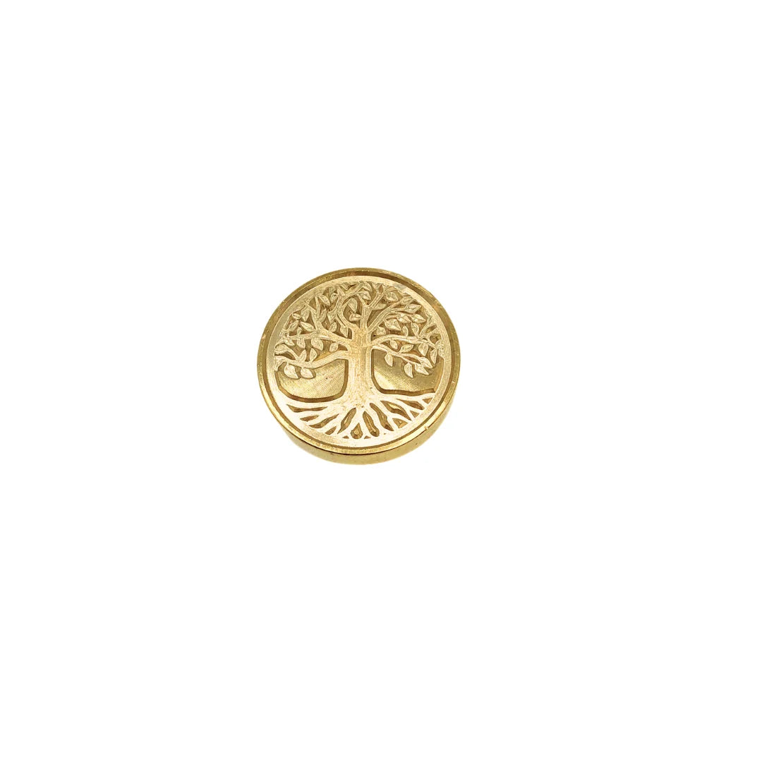 A single round gold-toned stamp-seal  featuring an embossed tree of life design, centered on a plain white background.