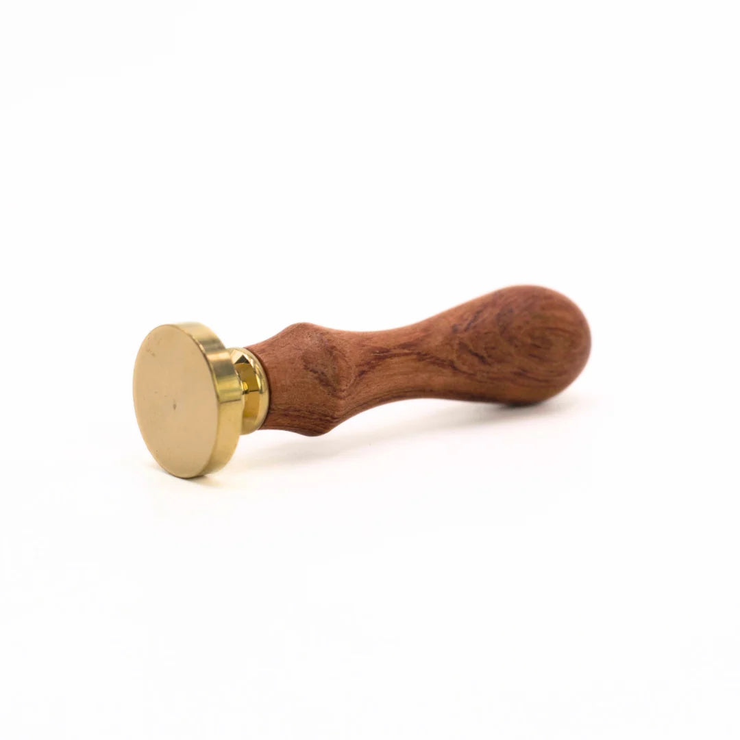 A wooden wax seal stamp with a polished brown wood handle and a round brass head, shown on a clean white background.