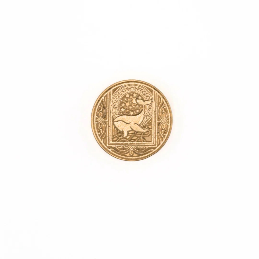 A single round gold-toned stamp-seal with an embossed animal and decorative border, centered on a plain white background.